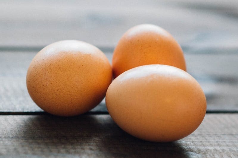 Three eggs with shell on table